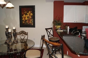 Dining and Kitchen with granite counter tops and bar stools