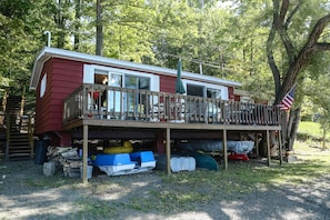 The Main House sweeping deck with lots of watercraft underneath