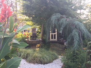 view of cottage rear entrance to kitchen through garden