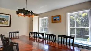 Dining area with mahogany table and built-in window seat.