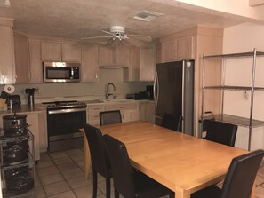 Kitchen and Dining with seating for up to 10.  Extra leaf behind metal rack.