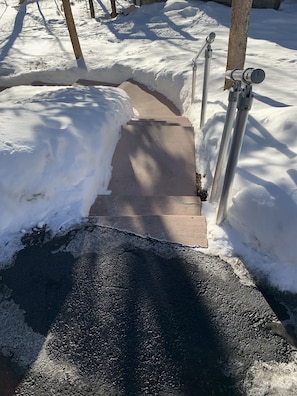 Top of walkway off of the right side of driveway that goes to the apartment