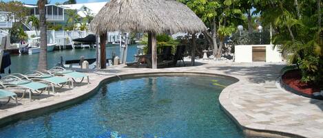 Heated pool with sitting area and Tiki.