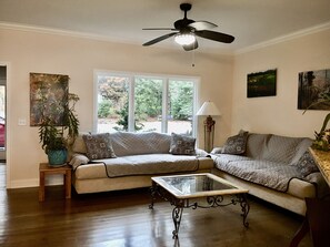 Living room with garden and lake view.