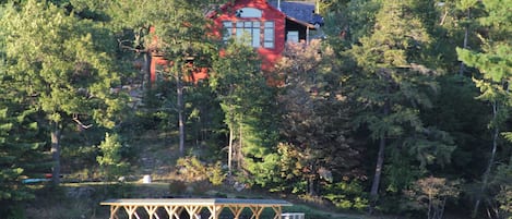 View of the house from the lake. Association dock with sun deck 