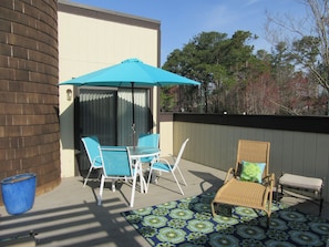 1st floor deck with table, chairs, lounger and rockers waiting for you to relax!