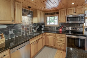 Kitchen has stainless appliances and granite countertops