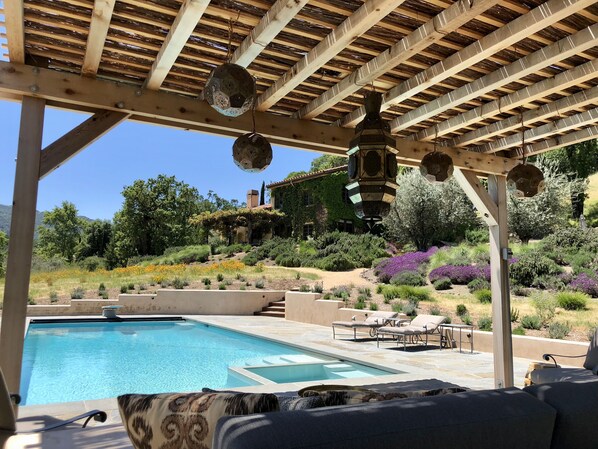 Shady retreat from the hot Summer sun under the reed covered pergola
