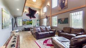 This spacious upstairs living room has multiple sitting areas, a 75" flat-screen TV area, and a large fireplace to provide a cozy atmosphere. Make yourself comfortable while you relax or visit with friends or family.