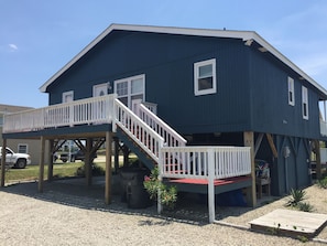 Back of our beach home with gravel parking area - can fit a boat.