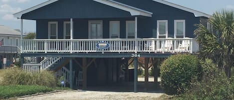 The front of our home (OceanzFive) from across the street. Carport under home.