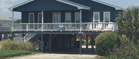 The front of our home (OceanzFive) from across the street.  Carport under home.