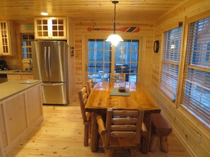 Dining area with patio doors leading out to private hot tub and private fire pit