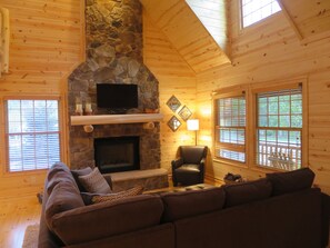 Wood burning fireplace with web connected TV hanging above.