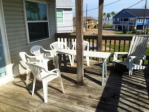 Front deck with roof and view of big boats on the Intracoastal Waterway.