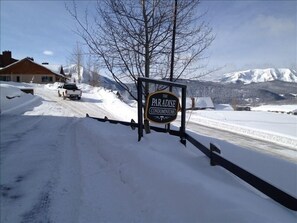 Paradise Condos, winter bus stop in front of sign, right outside condo.