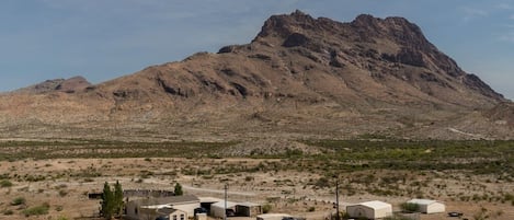 Ranch Compound with main Ranch House, three carports (one used for gatherings), game shack, wildlife feed paddock, East Corazones Peak in background