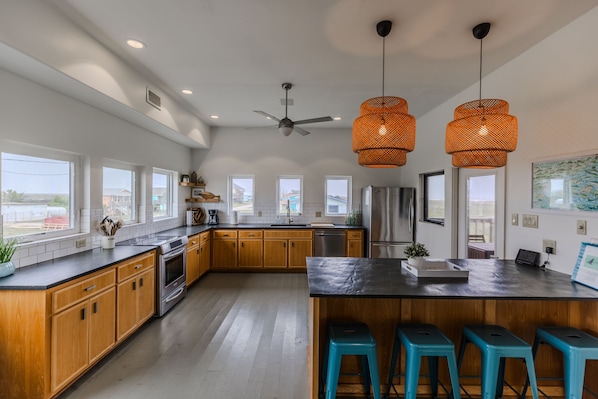 Fully stocked modern kitchen with bar seating for 4