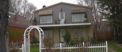 Front of property with large front porch and upper deck.