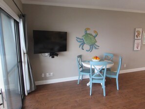 Dining table and new, flat screen TV.