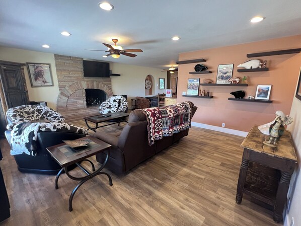 Living room has lots of comfortable seating, 50" HD TV & aux-enabled stereo
