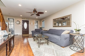 living room with sofa, chair, 40 inch flat screen with Verizon FIOS & DVD player