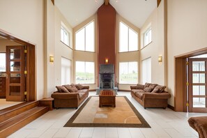 Living room with cathedral ceiling & balcony. 10 Ft Soapstone fireplace.