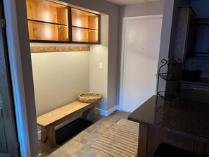 Entry hall with a bench and cubbies above for helmets, etc.