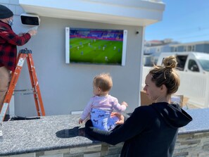 Outdoor bar, 65in tv and fridge 