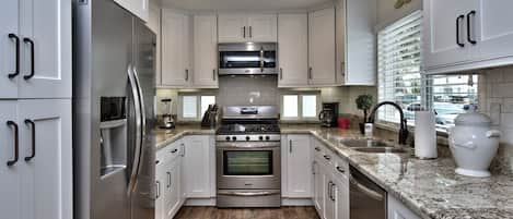 Bright Granite Kitchen with Stainless Steel Appliances