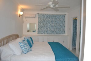 Bedroom, with window blind down, and door to bathroom