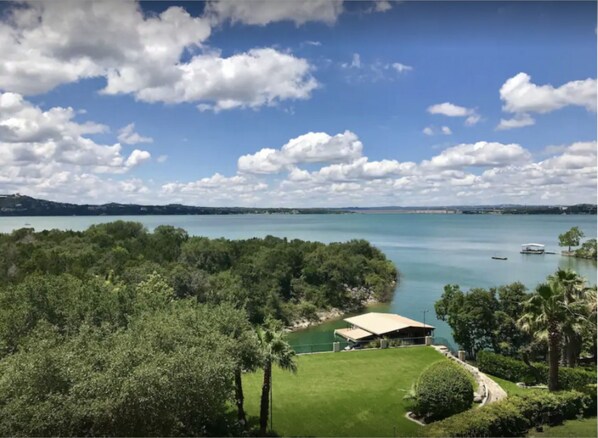 View of the backyard, cove, and dock with Lake Travis' main basin in background