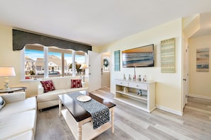 View to see front door and interior entry door into comfortable living room.