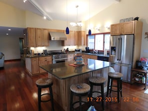 Open Kitchen, Silestone Island countertop with bar stools and vaulted ceiling