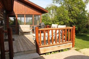 porch with bbq and tanning chairs
