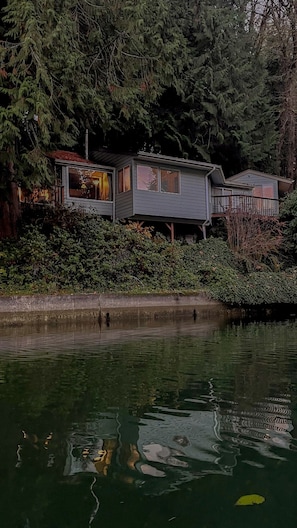 View of the cottage at dusk from the water/middle of the cove.