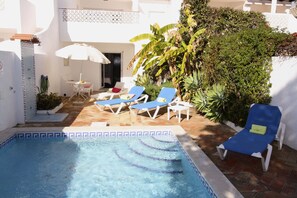 Steps from the pool area to the veranda and living area