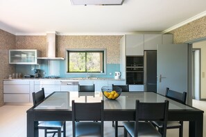 Fully equipped modern kitchen with dining space