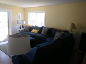 Large sectional that looks out to the ocean through sliding glass doors!