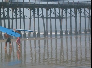 Surfers by the Pier