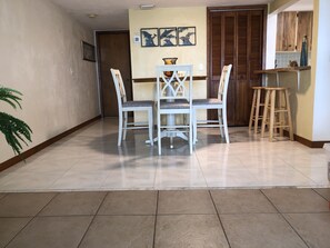 Kitchen eating area and extra stools along counter overhang.