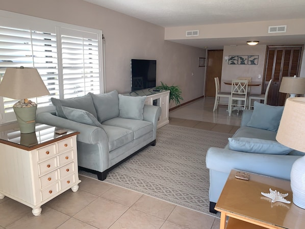 Photo taken standing in front of sliding door looking into the unit from patio.