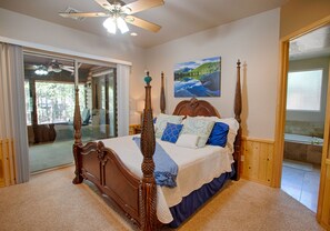 The primary bedroom suite is located on the main level and has direct access to the porch and a spacious ensuite bathroom.