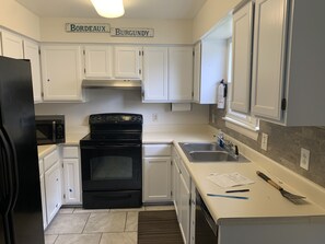 Full kitchen with dishwasher and microwave 
Basic dishes and cookware 