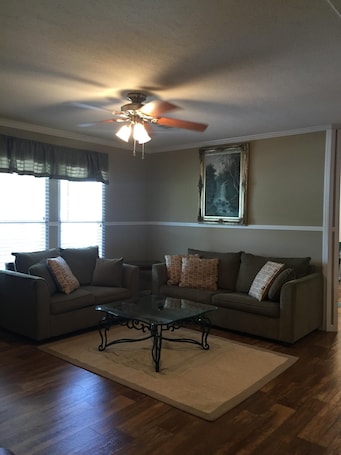 Living room. Linoleum throughout. No carpet to catch the sand. Great A/C & heat.