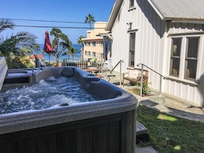 Hot tub in garden with ocean views!