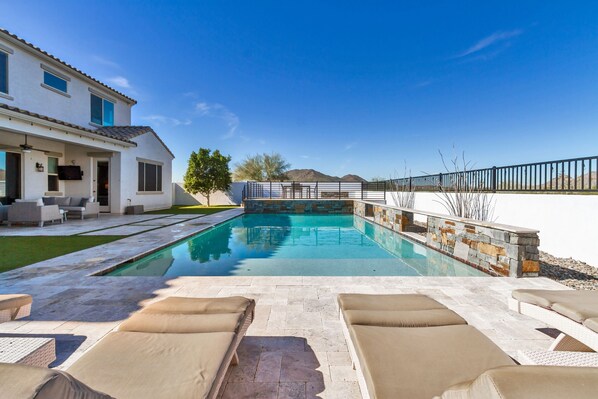 Backyard view from the Chaise Lounges by the Pool.  Baja step runs full width 