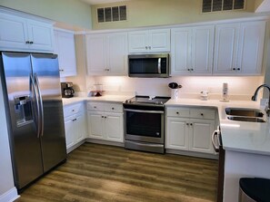 Well-appointed kitchen with Quartz Counter tops.