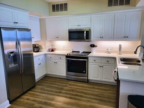 Well-appointed kitchen with Quartz Counter tops.