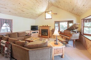 The second living room with piano, gas fireplace and a TV w/cable & 150+ DVDs.